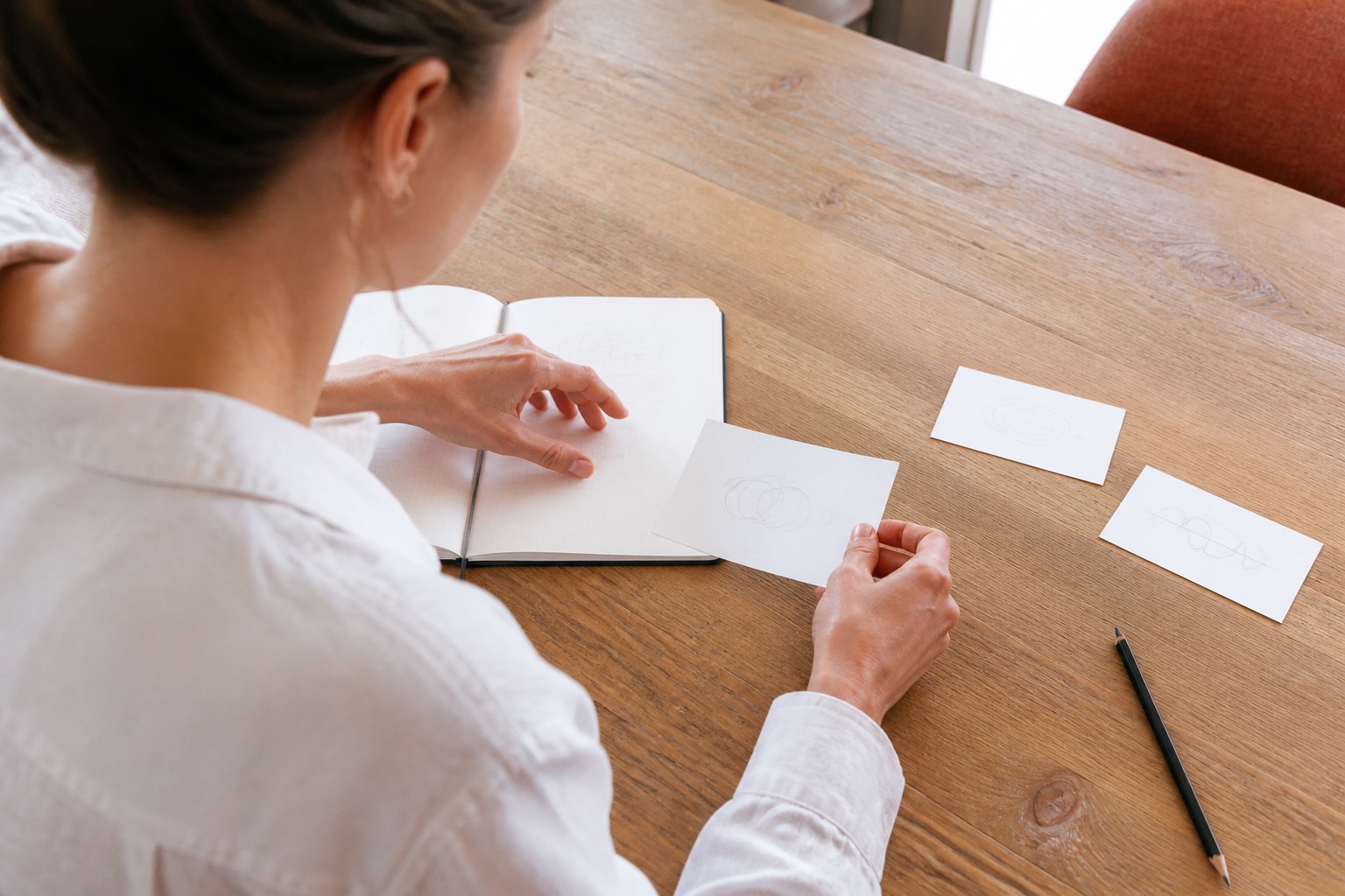 A creator choosing one idea from a table of possibilities