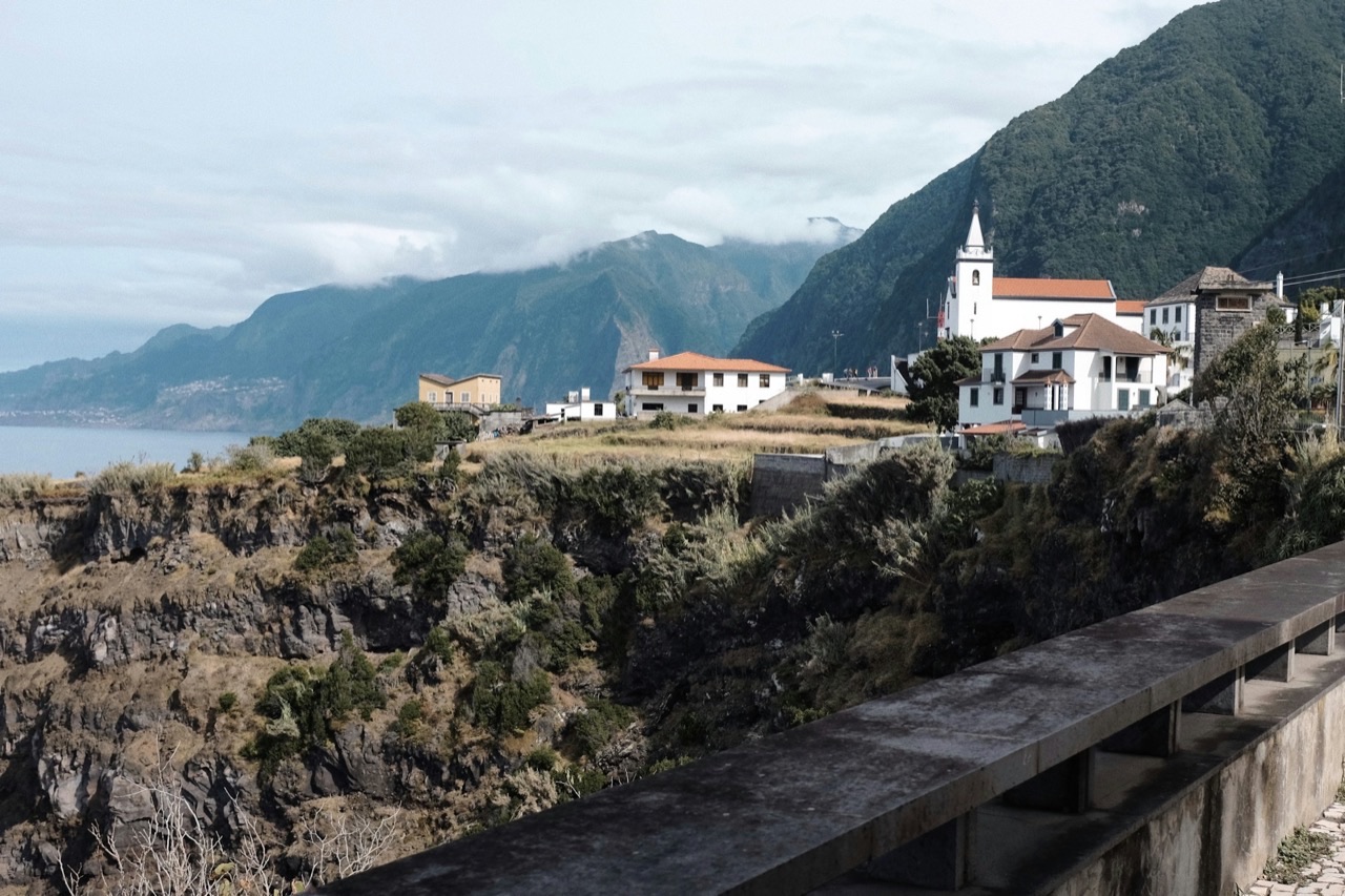 Madeira's volcanic mountains falling into the Atlantic beside a hillside village